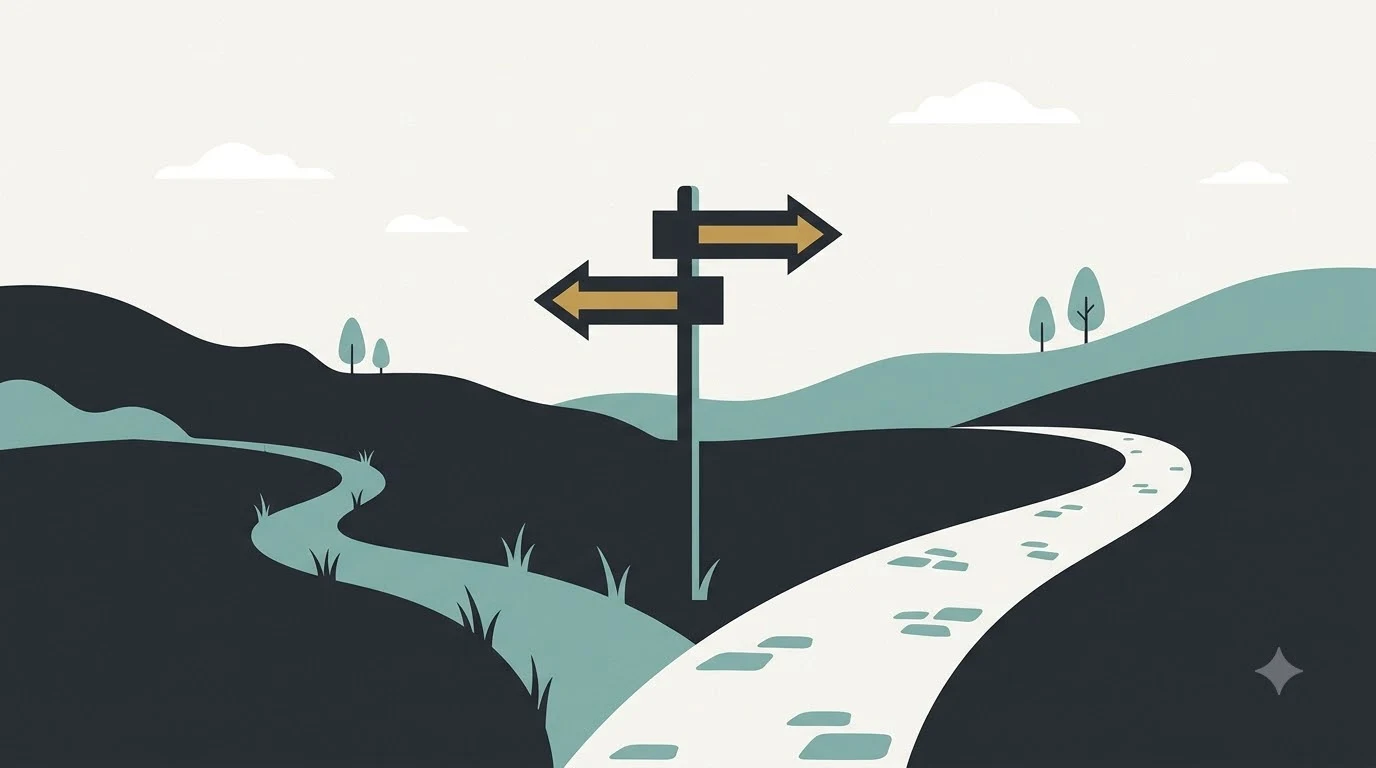 A signpost at a fork with two paths, one paved and one grassy